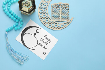 Card with text HAPPY ISLAMIC NEW YEAR, lantern, crescent and prayer beads on blue background