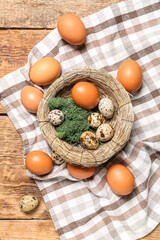 Nest with Easter eggs and moss on wooden background