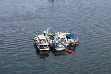 ships boats fishing trollers on ocean sea water of south China sea bay kota Kinabalu sabah