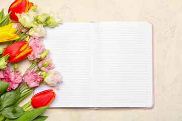 Blank open notebook and beautiful flowers on light background