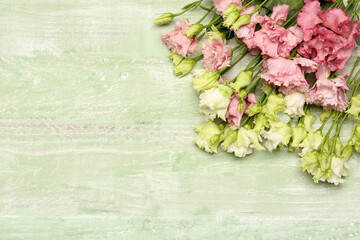Beautiful eustoma flowers on color wooden background