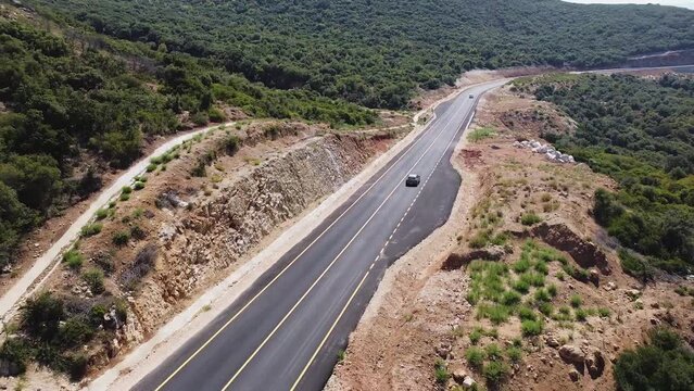 Aerial view of cars driving on a new mountain road in Albania