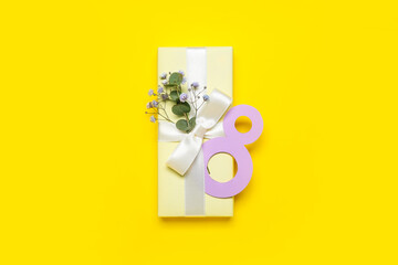 Beautiful gift for Women's Day celebration and paper figure 8 on yellow background