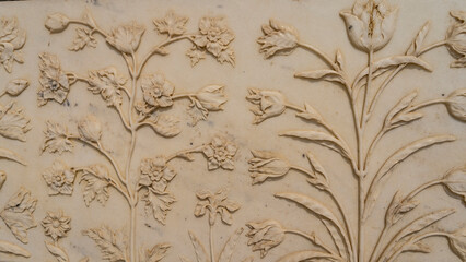 Details of the design of the ancient mausoleum of the Taj Mahal. On the white marble wall there is...