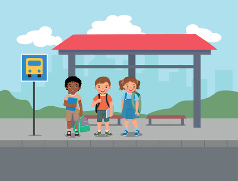 Group of little students waiting for school bus at the bus stop