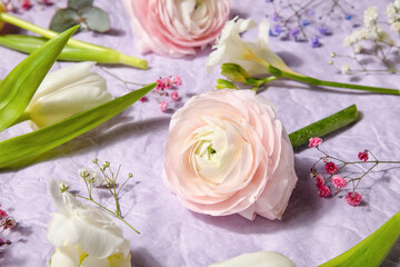 Composition with beautiful spring flowers on crumpled paper background