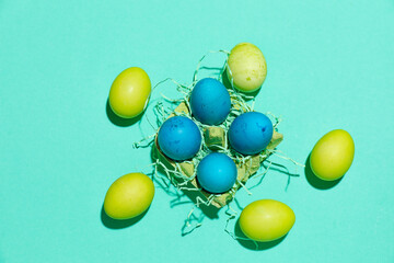 Holder with beautiful painted Easter eggs on color background