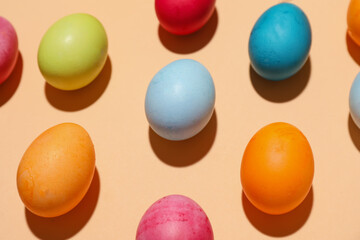 Many colorful Easter eggs on color background, closeup