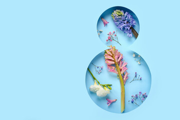 Spring flowers visible through cut color paper in shape of figure 8. Women's Day celebration