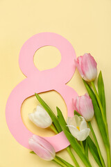 Beautiful tulip flowers and paper figure 8 on color background. Women's Day celebration