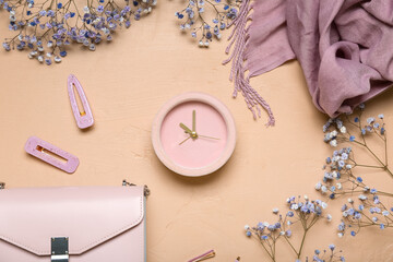 Fototapeta na wymiar Composition with alarm clock, gypsophila flowers and female accessories on color background