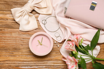 Composition with alarm clock, stylish female accessories and alstroemeria flowers on wooden...