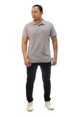 Man wearing casual grey shirt black denim and white shoes, looking to the side, front view. Full body portrait isolated