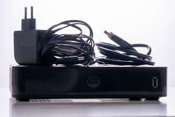 TV set-top box prepared for installation, digital TV kit on white background close-up with reflection
