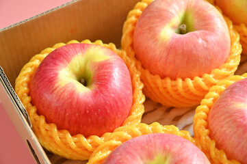 beautiful pink apple in the box on pink background