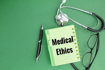 stethoscope, pen and glasses with the word Medical Ethics. concept of medical ethics