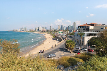 Fototapeta na wymiar Promenade and free beach in the old town of Yafo and the skyscrapers of Tel Aviv in the distance, in Tel Aviv - Yafo city, Israel