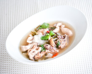 Tom Yum Chicken with Mushroom Straw on a White Bowl - selective focus