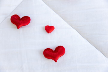 Heart shape with Gift box packed for honeymoon lover on white bed honeymoon suit.Valentine's day concept. Beautiful blurry background.heart lay on the bed.