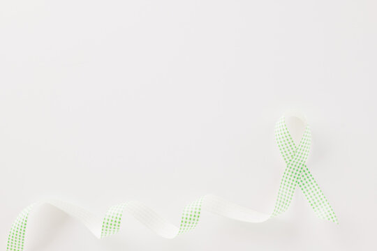 Green awareness ribbon of Gallbladder and Bile Duct Cancer month isolated on white background with copy space, concept of medical and health care support