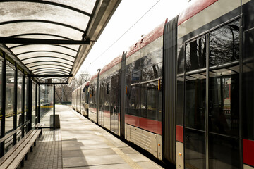 Public transport scene in Gdansk. Empty transport stop. No people Tram arrives at the tram stop....