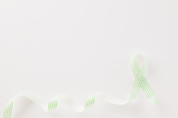 Green awareness ribbon of Gallbladder and Bile Duct Cancer month isolated on white background with copy space, concept of medical and health care support