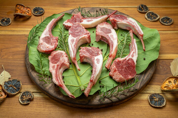Australian lamb rack cutlets or Raw Frenched Rack 8 Ribs on wooden plate.