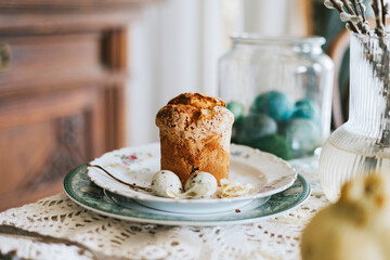 table set for Easter on veranda on sunny spring day decorated with flowers and Easter decor, eggs, cake and willow branches, Easter family celebration, grain and noisy effect