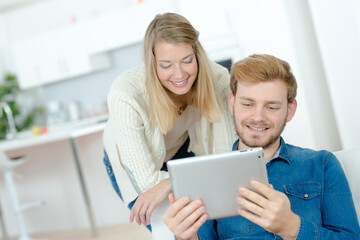 young couple looking at a tablet