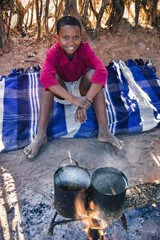 African village boy cooking