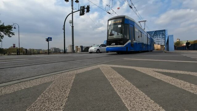  The electric light rail on the main street in the city of Krakow. Background of clear autumn sky