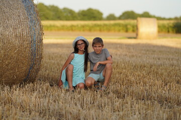 Puppy love. Teenagers in love sit near a haystack.