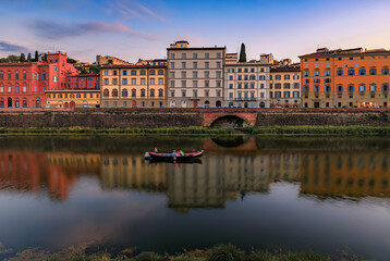 Fototapeta na wymiar Sunset cityscape with waterfront houses on Arno River, Florence, Italy
