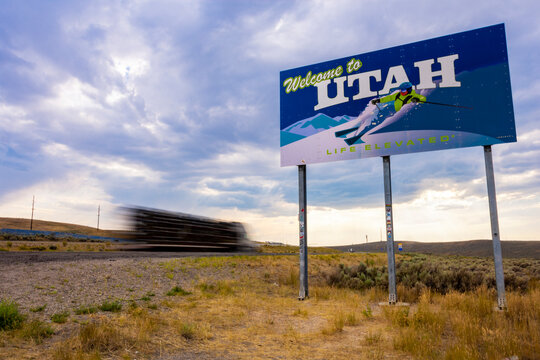 Truck Driving Past Welcome To Utah Sign