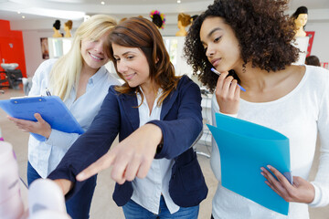 hairdressing trainer pointing at salon product