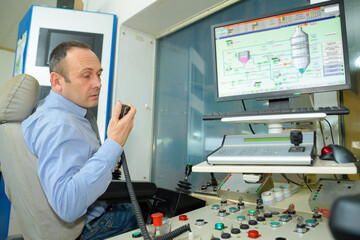 control center worker talking into radio receiver