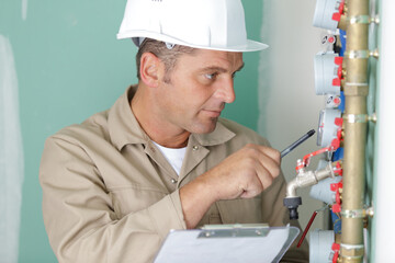 plumber installing pressure meter for house heating system