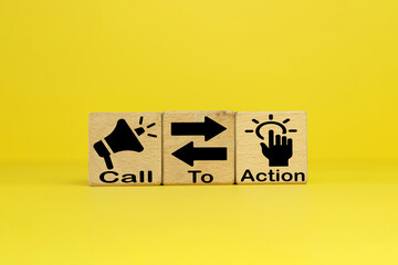 CTA(Call To Action) word and icon on wooden cubes over yellow background use for advertising, social media, and marketing materials concept.