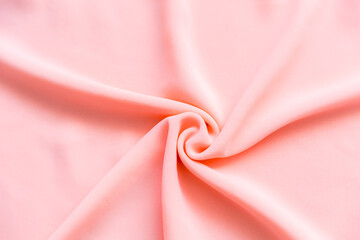 Light pastel pink folded fabric as a background