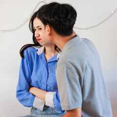 Millennial Asian young romantic cheerful lover couple male boyfriend try to sorry reconcile angry...