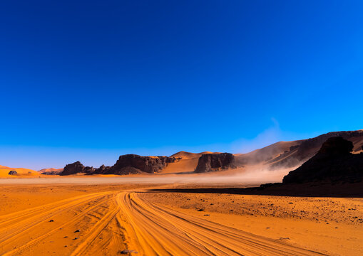 Car tire marks in the sand in Sahara desert, Tassili N'Ajjer National Park, Tadrart Rouge, Algeria