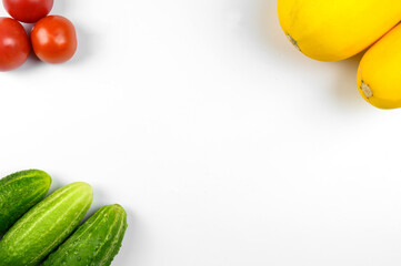 Layout of ripe tomatoes, zucchini, cucumbers on a white background. The concept of cooking, organic vegetables. Top view.