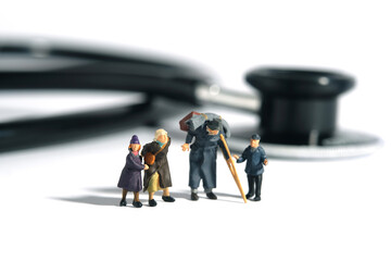 Miniature people toy figure photography. A group of poor family grandpa, grandma, and two...