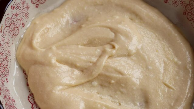  Put the dough into a baking dish. Stages of preparation of cuca de banana. Silicone spatula to spread the dough