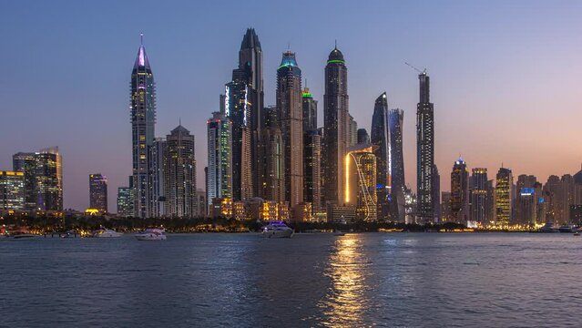 Time lapse of Dubai skyline - Marina skyscrapers from day to night, United Arab Emirates