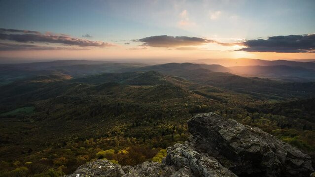 Time lapse of Sunset in a rocky forest landscape with autumn nature. Stiavnicke hill, Sitno, Slovakia.
