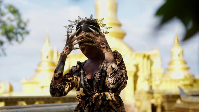 Woman With Gold Dancing Outside Khmer Temple