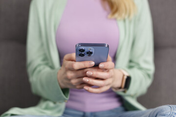 Woman typing message in smart phone app. Close up photo of unrecognizable adult female person using mobile phone for communication