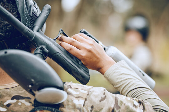 Man in paintball game, gun in hand and sports, fitness and battlefield challenge, war and soldier outdoor. Extreme sport, exercise with shooting range and military mission and training in camouflage