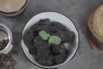 Small brownies cake in white bowl with topping mint leaf, Close Up